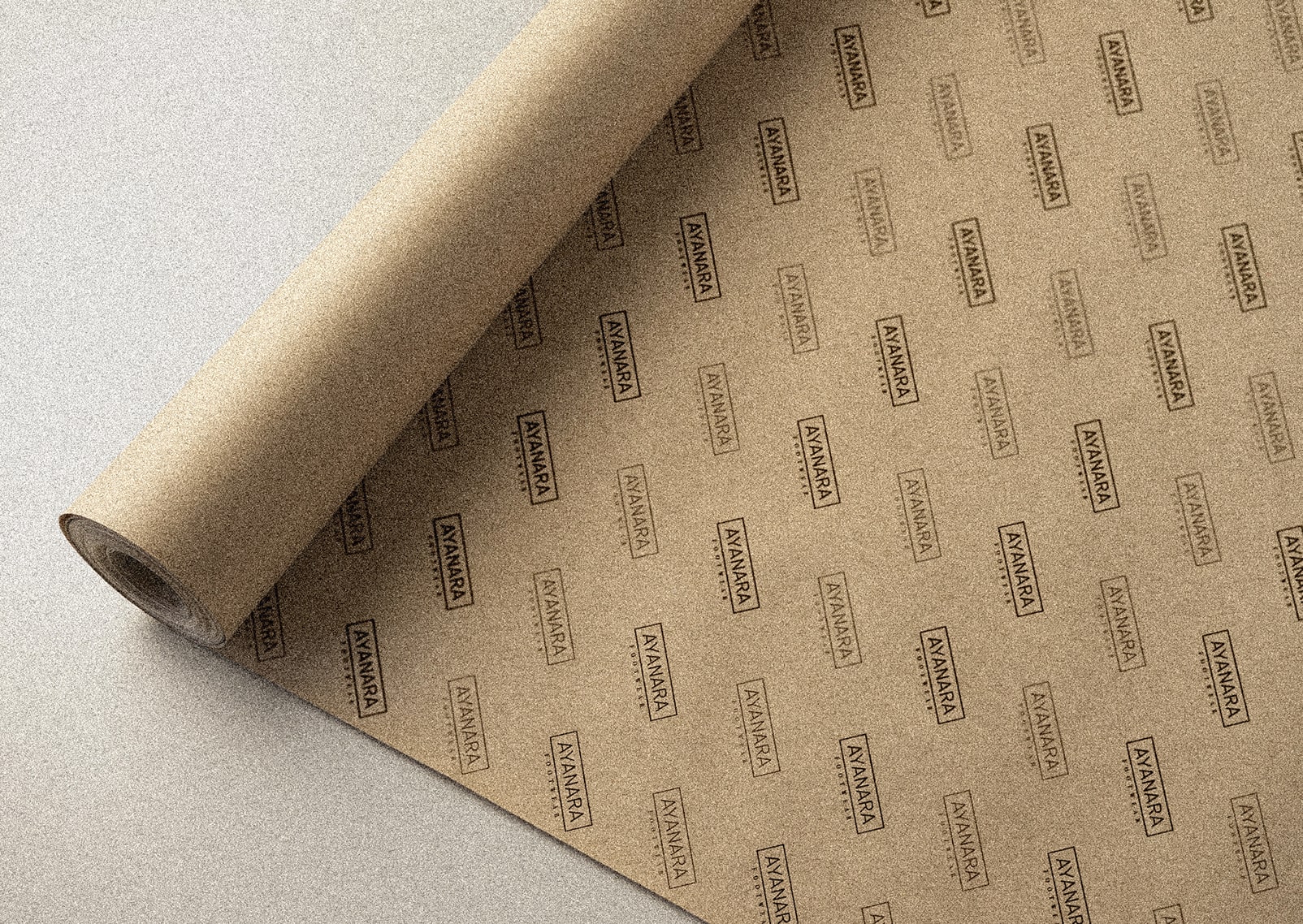 A rolled sheet of custom-branded kraft paper featuring the "AYANARA FOOTWEAR" logo in a repeated pattern. The natural brown texture of the paper complements the minimalist black logo design, creating an eco-friendly and stylish packaging solution. Perfect for wrapping products while reinforcing brand identity.