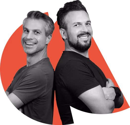Two smiling men standing back-to-back, showcasing a confident and friendly demeanor